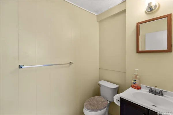a bathroom with a sink mirror and toilet
