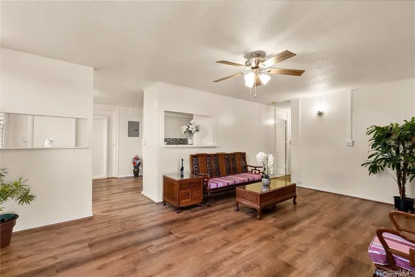 a living room with furniture and wooden floor