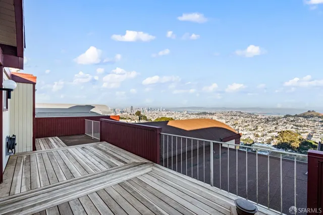 a view of roof deck with two couches and wooden floor