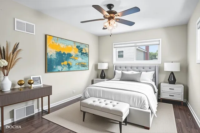 a bedroom with a bed and a painting on the wall