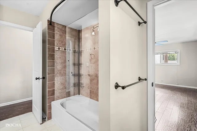 a bathroom with a glass shower door