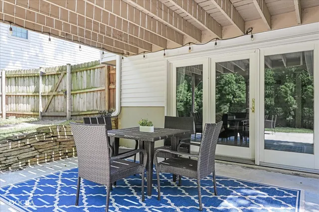 a view of a patio with table and chairs and potted plants