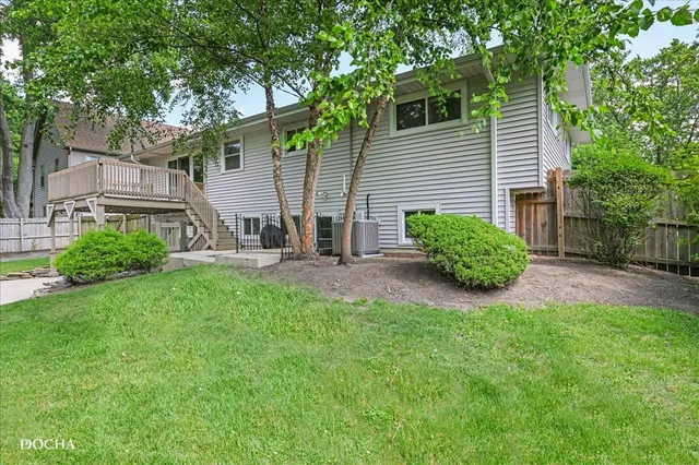a view of a chair and table in backyard of the house