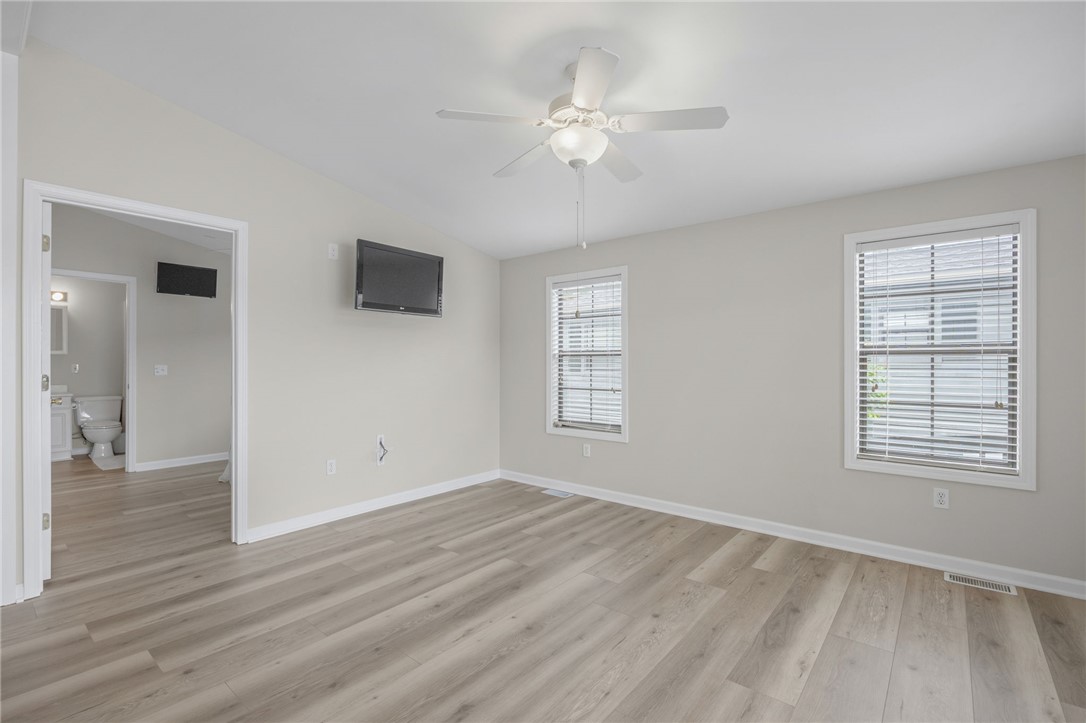 1230 Melton Road, Unit 25 West Union, SC 29696 - Photo 3 of 46 A pristine bedroom retreat with light wood-tone flooring and a ceiling fan, offering a tranquil escape.
