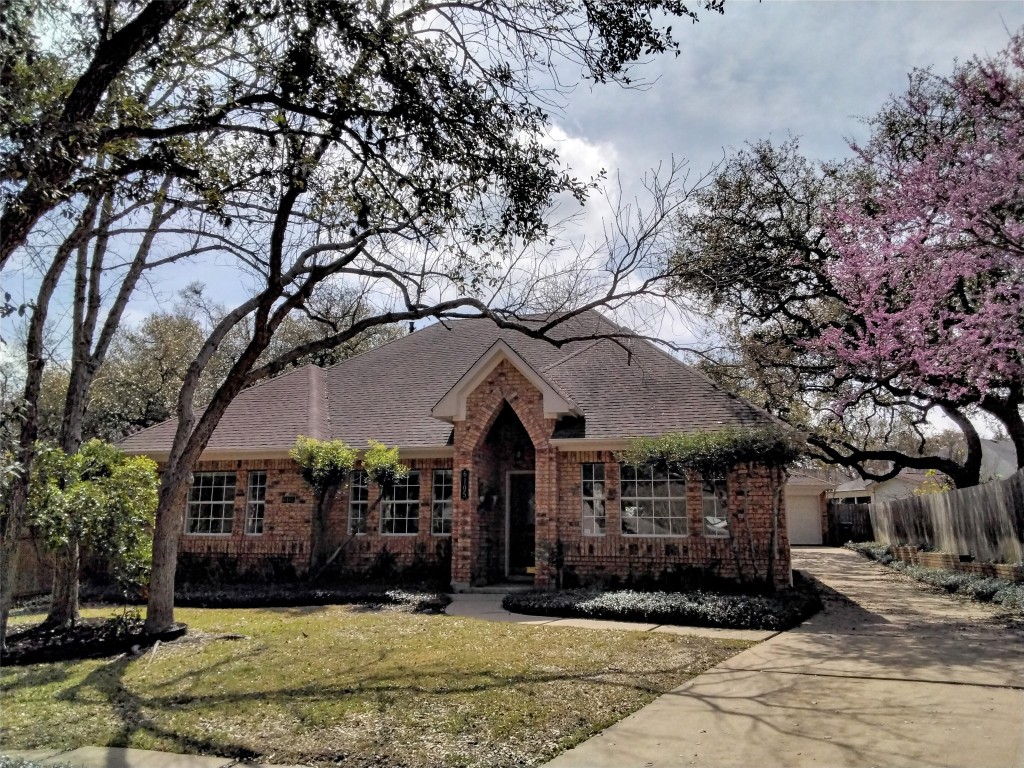 6105 Rickerhill Lane Austin, TX 78739 - Photo 1 of 1 a front view of a house with a yard