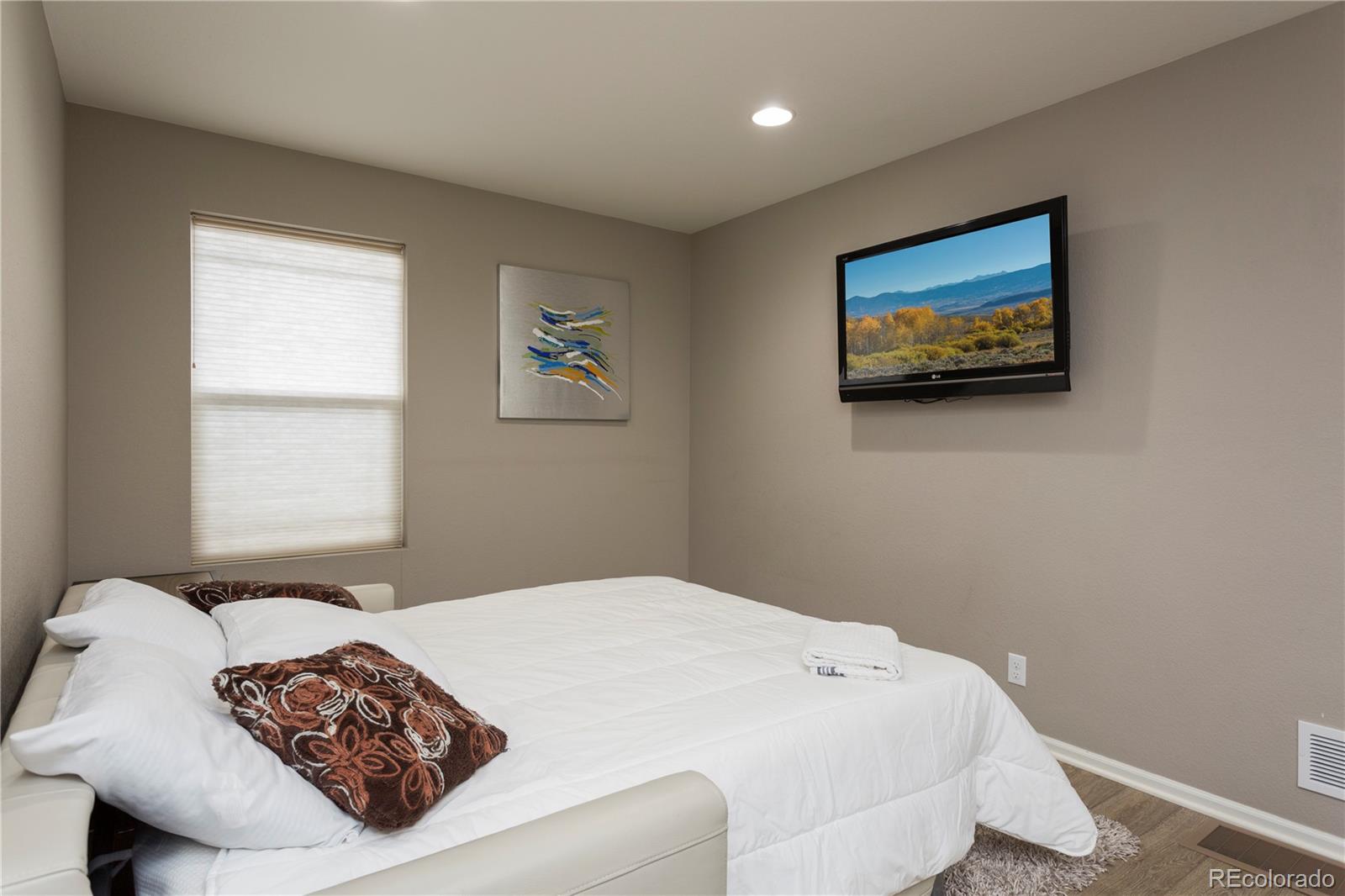 2834 Macon Way Denver, CO 80238 - Photo 18 of 36 a bedroom with a bed and a painting on the wall