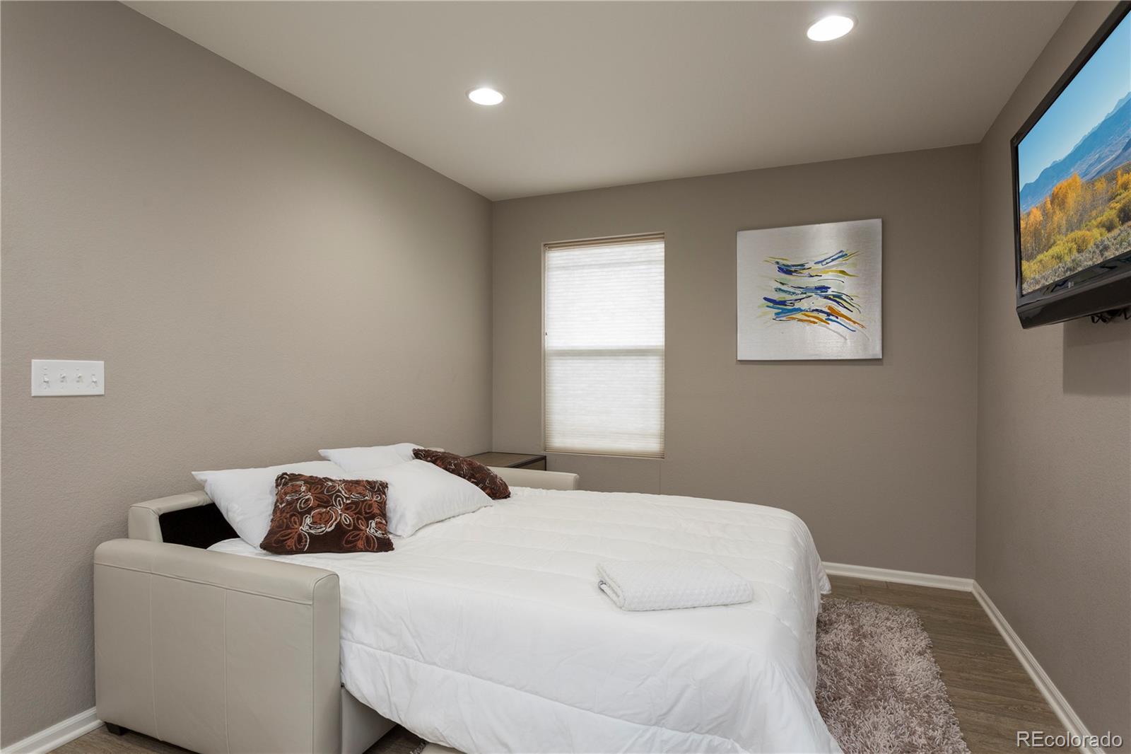 2834 Macon Way Denver, CO 80238 - Photo 19 of 36 a bedroom with a bed and a window