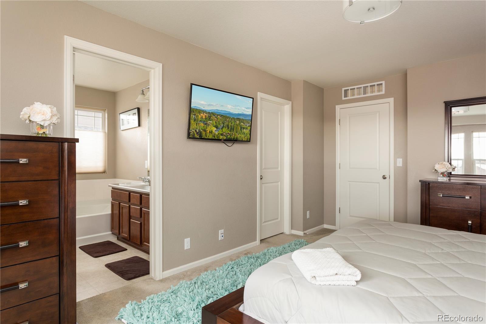 2834 Macon Way Denver, CO 80238 - Photo 22 of 36 a bedroom with a bed and a dresser