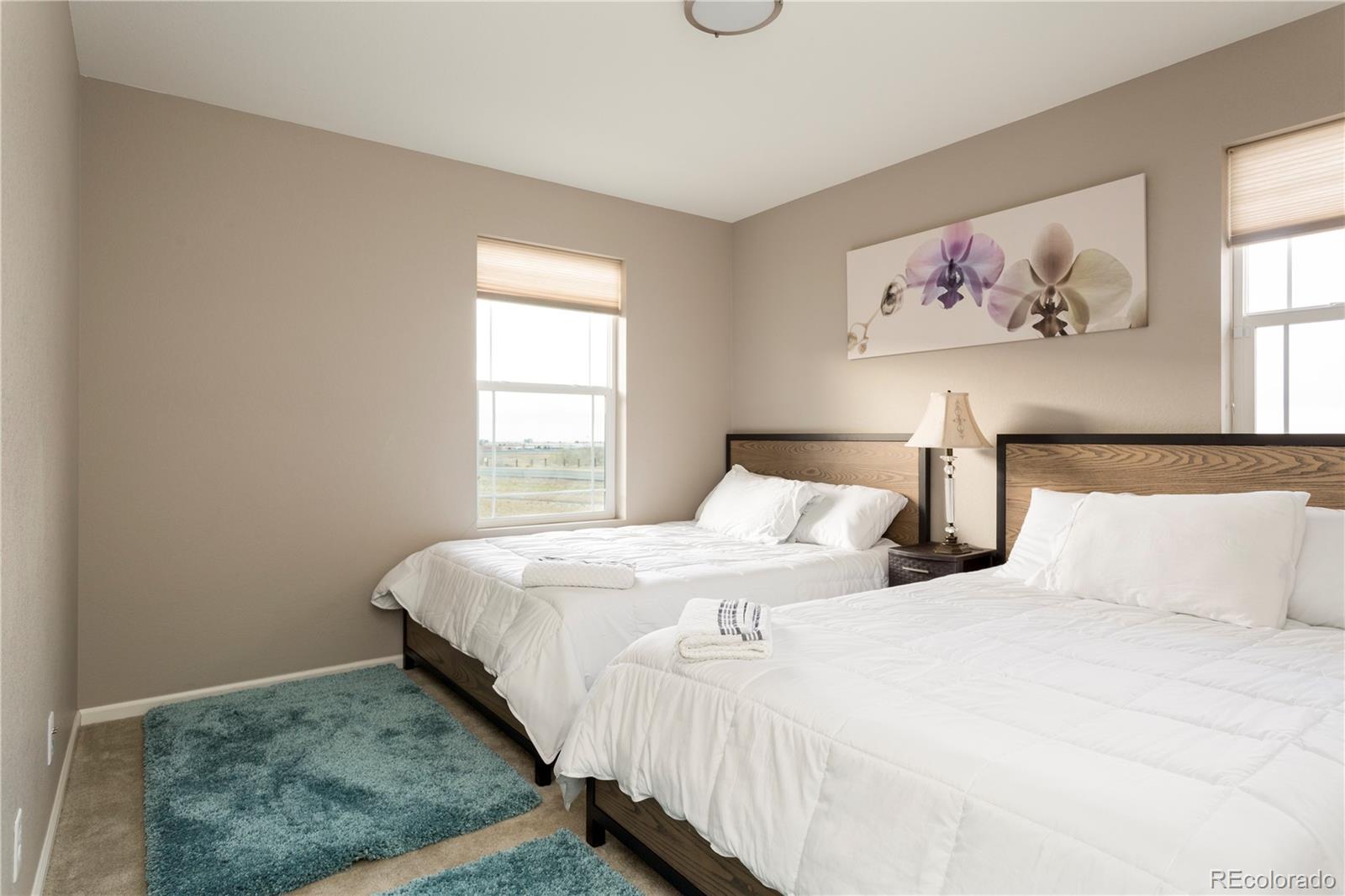 2834 Macon Way Denver, CO 80238 - Photo 26 of 36 a bedroom with a bed painting on the wall and a window