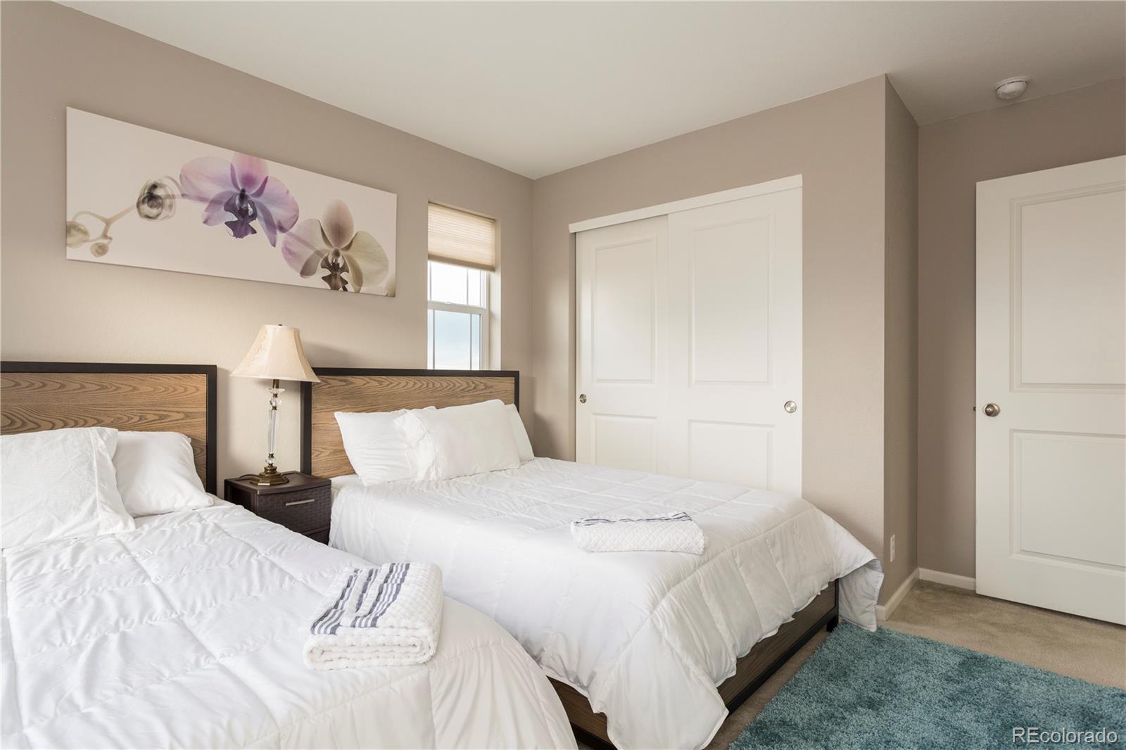 2834 Macon Way Denver, CO 80238 - Photo 27 of 36 a bedroom with a bed and painting on the wall