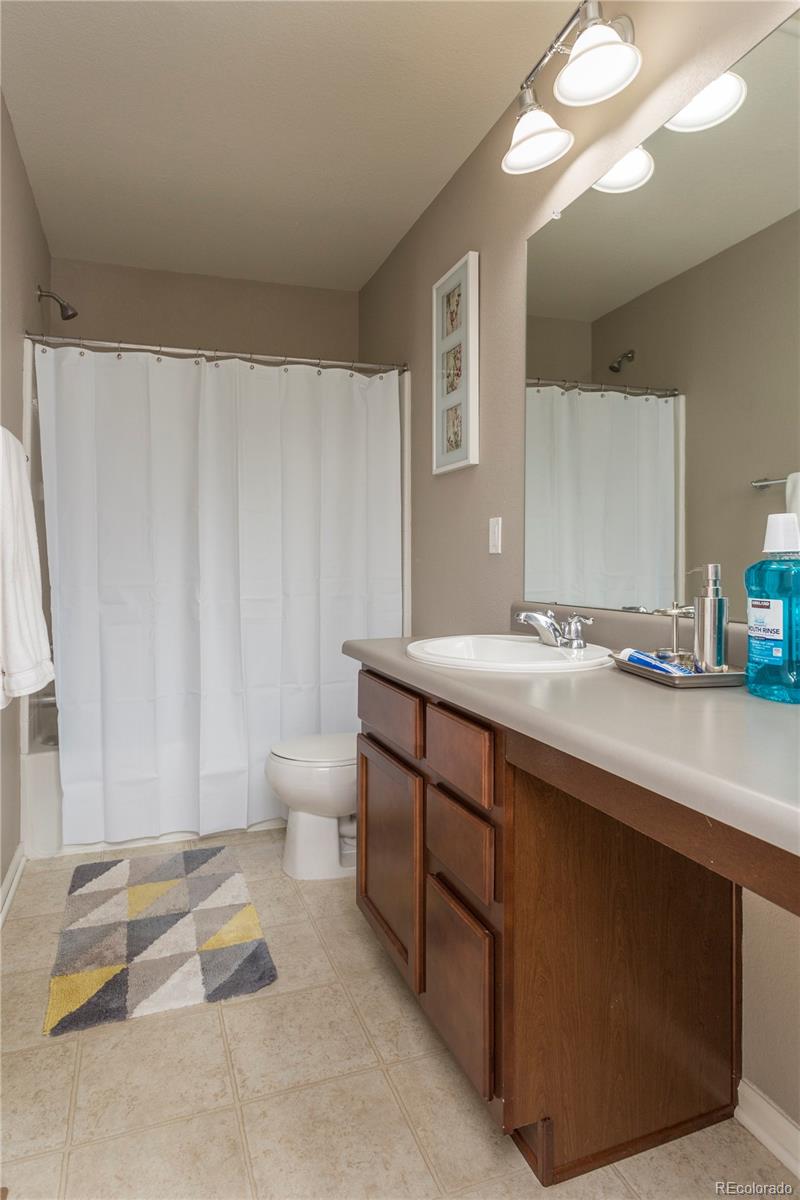 2834 Macon Way Denver, CO 80238 - Photo 29 of 36 a spacious bathroom with a double vanity sink toilet and a mirror