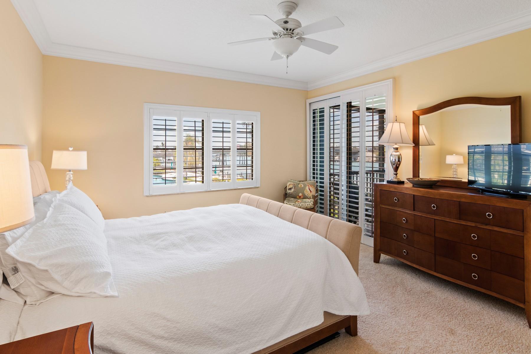 275 South Beach Road, Unit C203 Jupiter, FL 33469 - Photo 11 of 21 a bedroom with a bed and a window