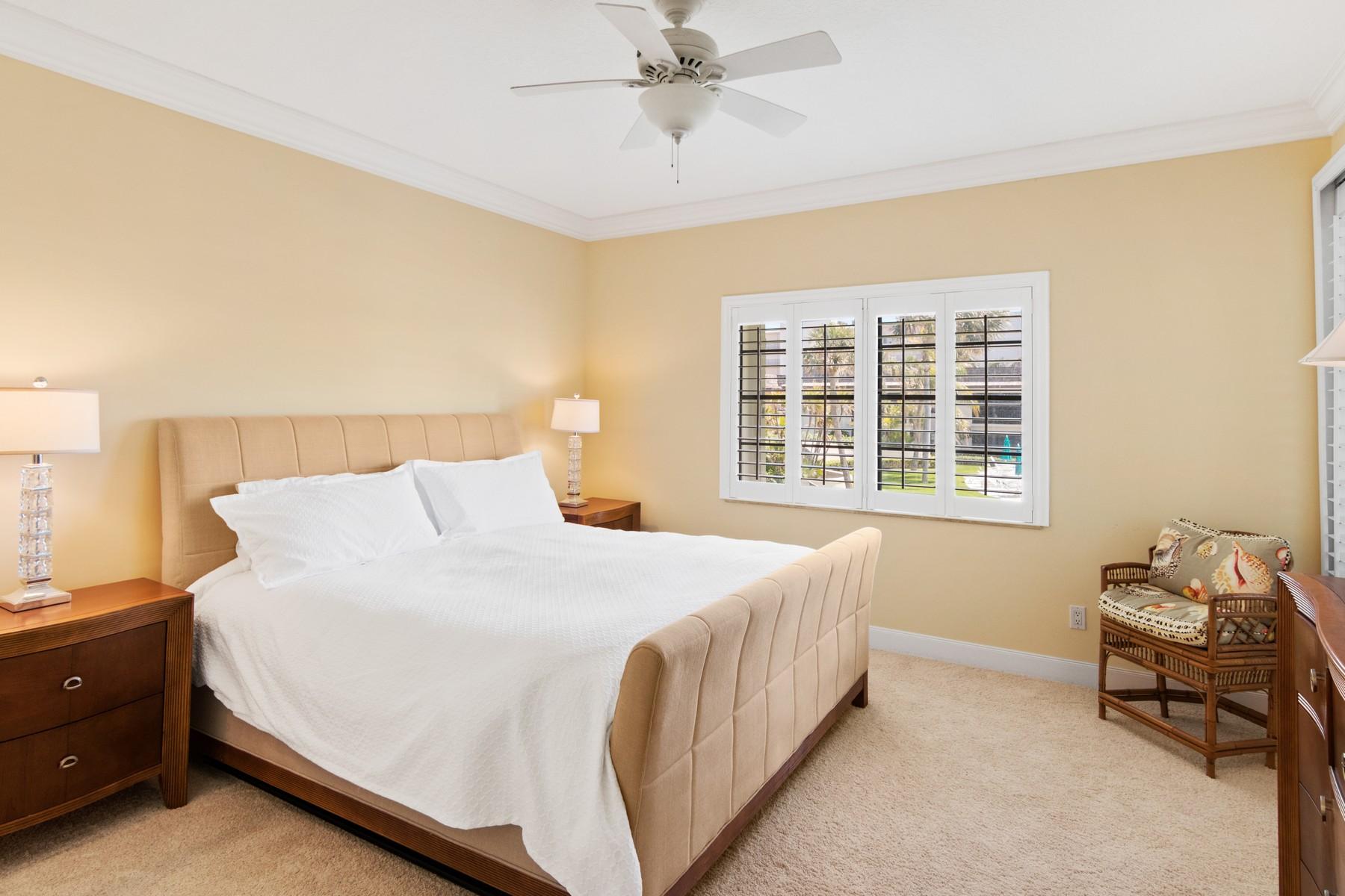 275 South Beach Road, Unit C203 Jupiter, FL 33469 - Photo 12 of 21 a bedroom with a bed and window