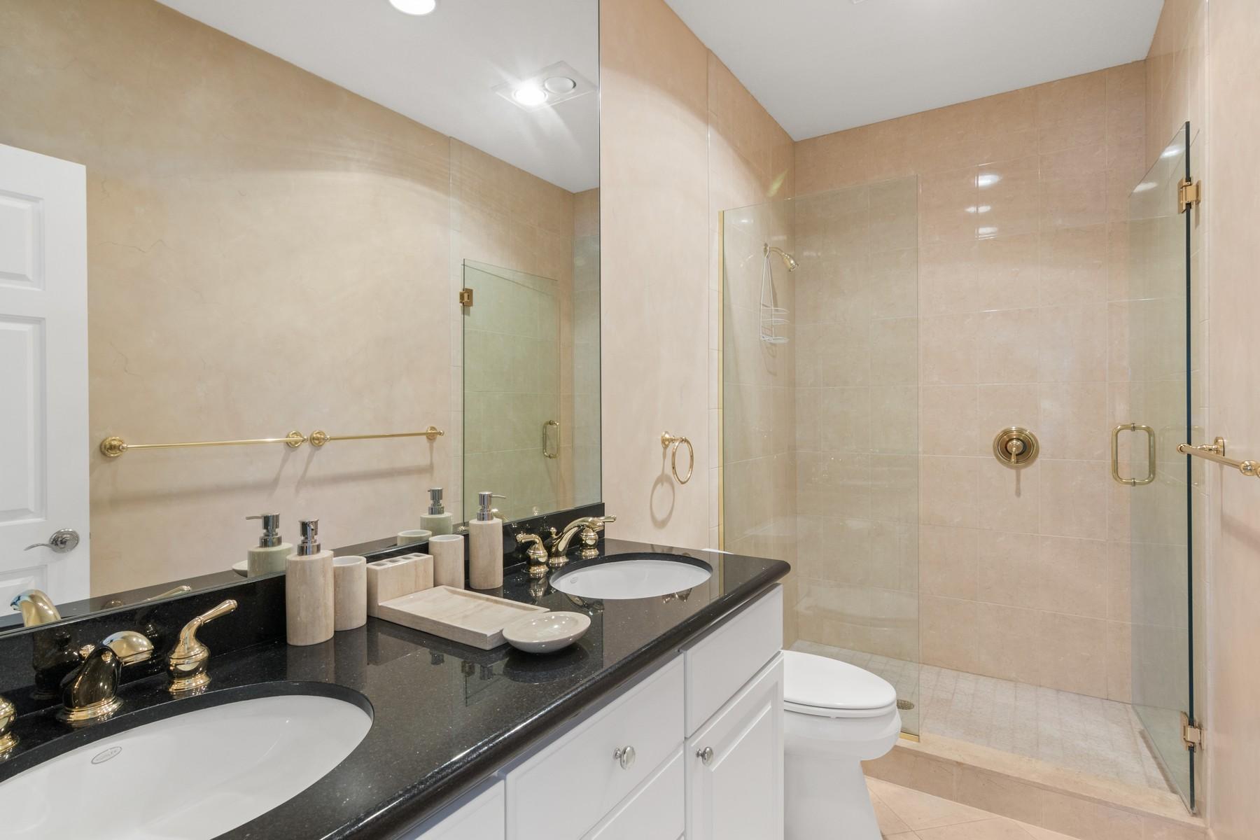 275 South Beach Road, Unit C203 Jupiter, FL 33469 - Photo 13 of 21 a bathroom with double sink and a mirror