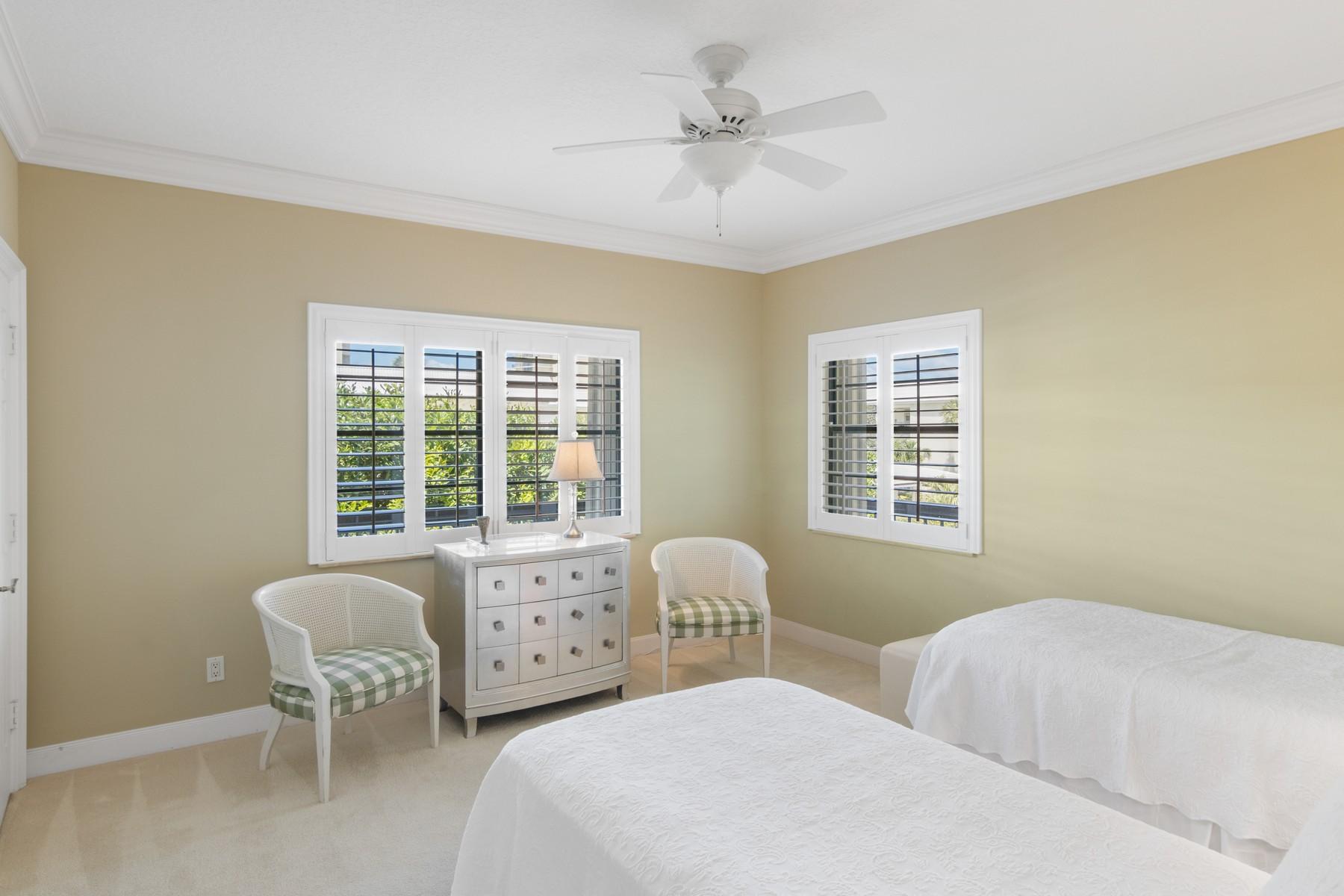 275 South Beach Road, Unit C203 Jupiter, FL 33469 - Photo 15 of 21 a bedroom with two beds and a chair