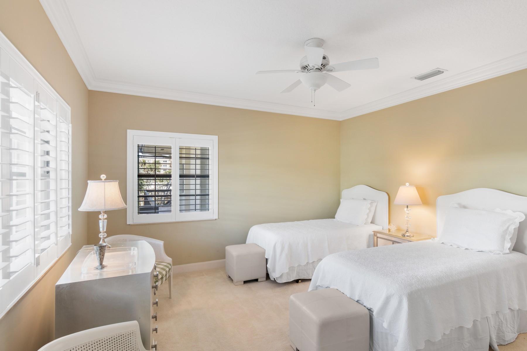 275 South Beach Road, Unit C203 Jupiter, FL 33469 - Photo 16 of 21 a bedroom with two beds and ceiling fan