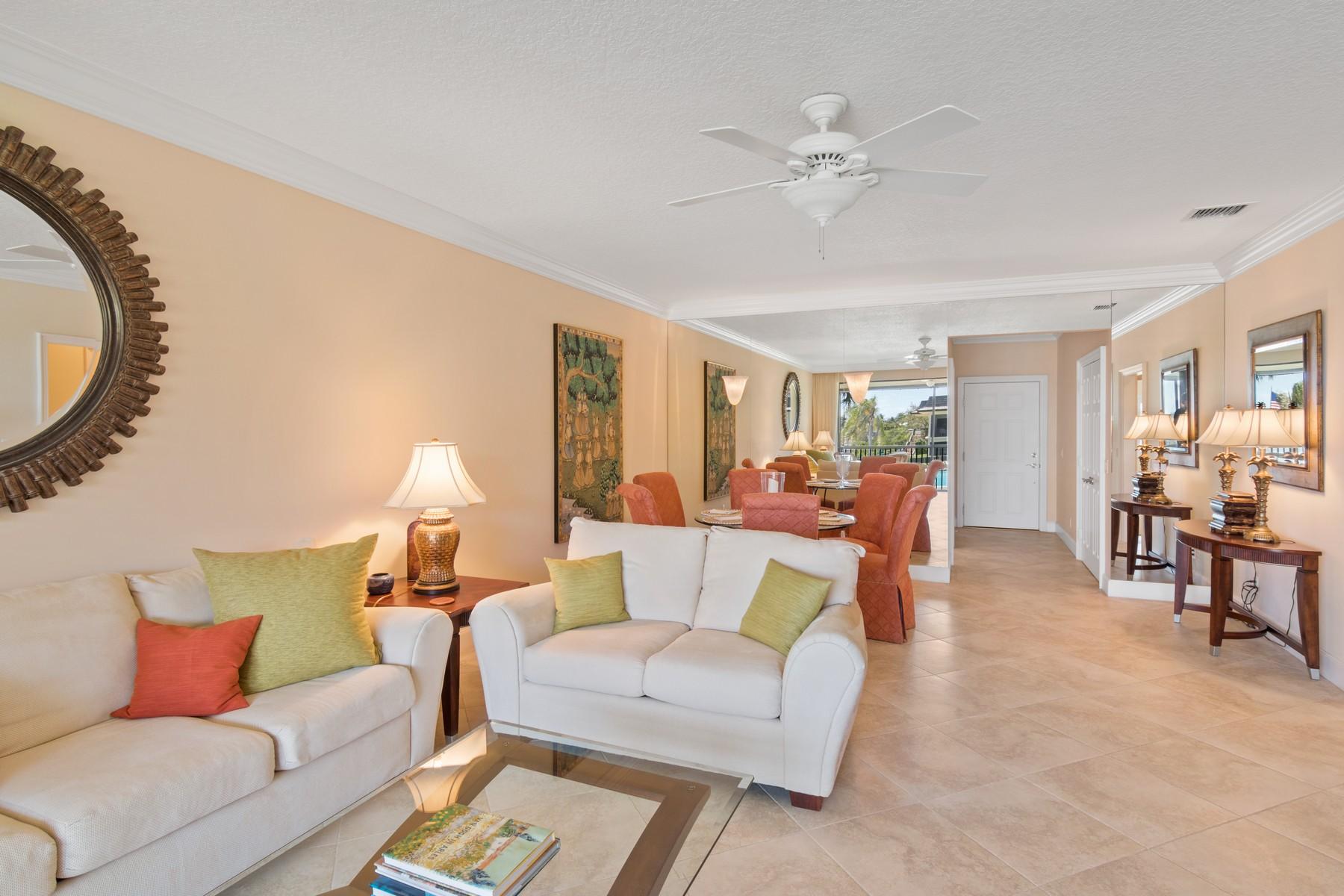 275 South Beach Road, Unit C203 Jupiter, FL 33469 - Photo 6 of 21 a living room with furniture and a chandelier