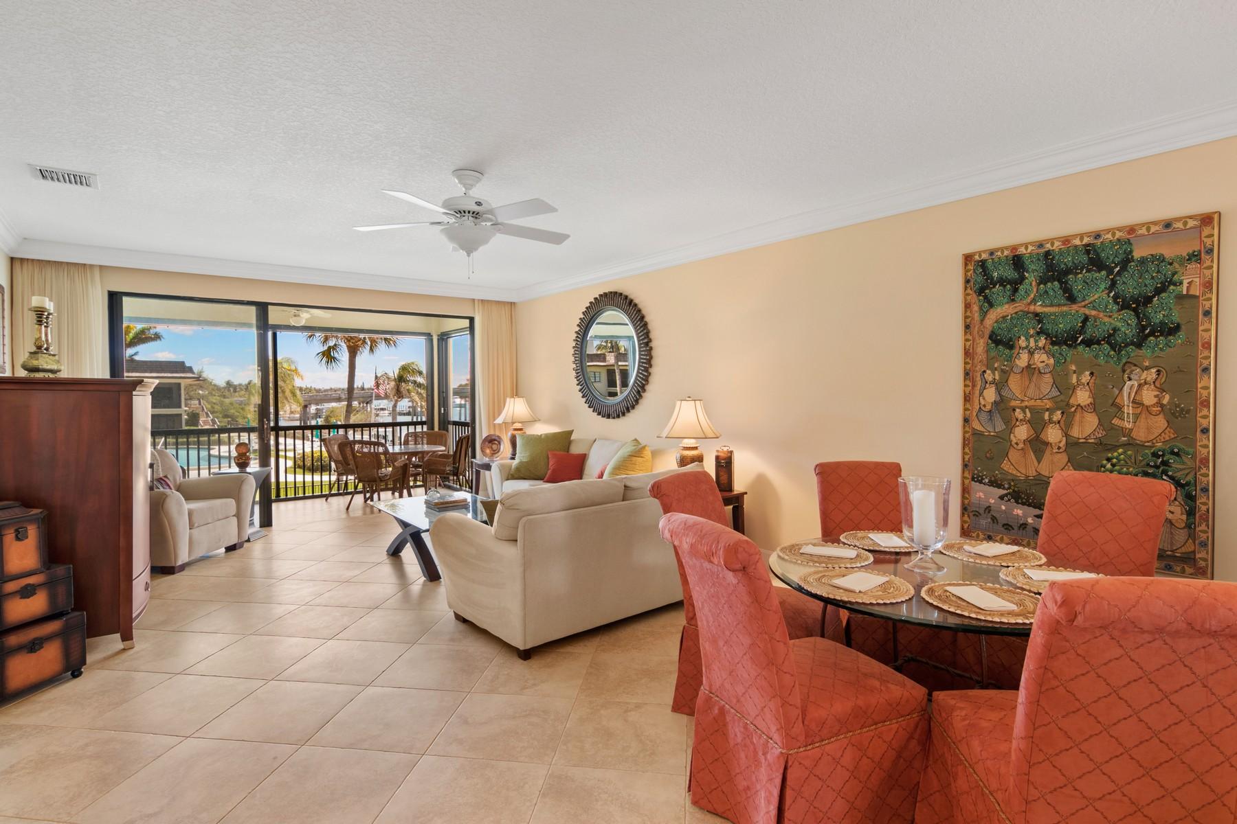 275 South Beach Road, Unit C203 Jupiter, FL 33469 - Photo 7 of 21 a living room with furniture a large window and a clock