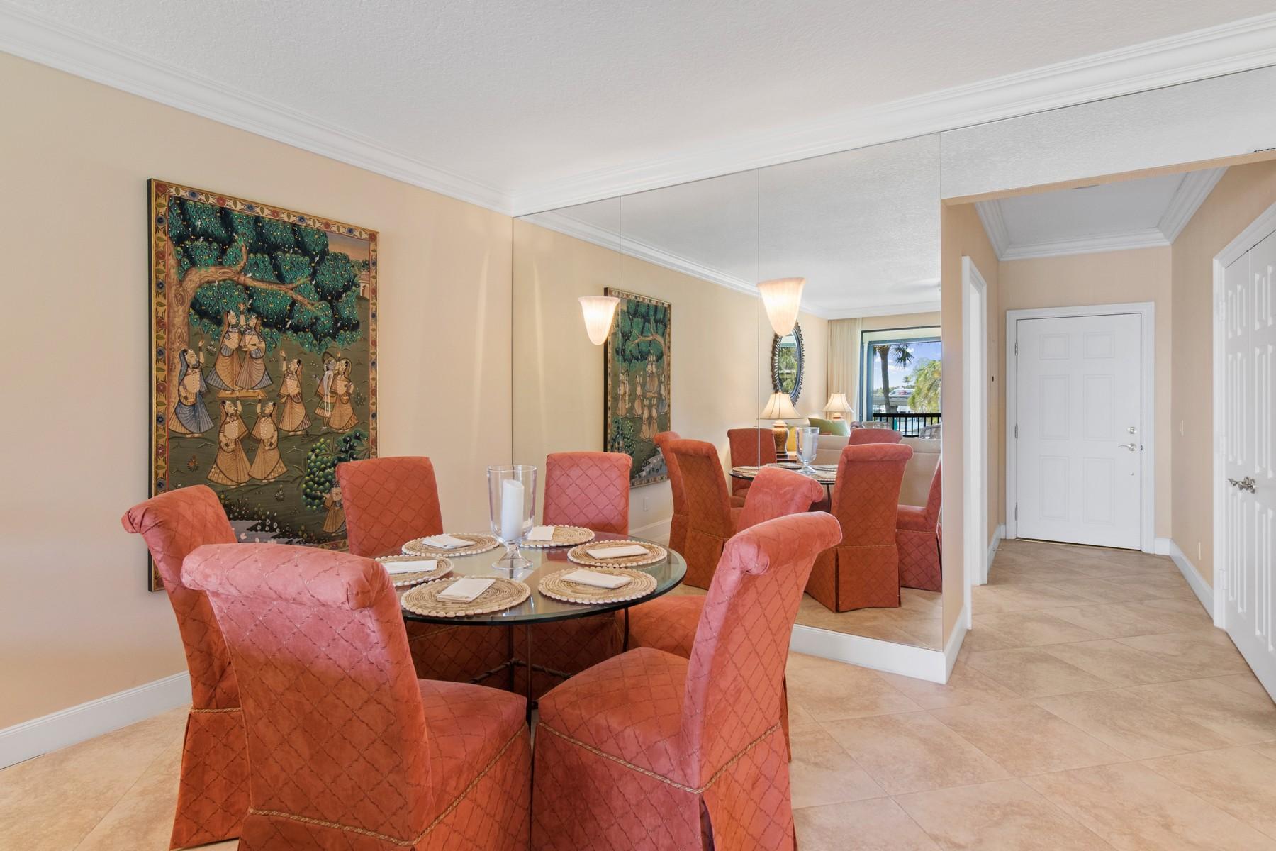 275 South Beach Road, Unit C203 Jupiter, FL 33469 - Photo 8 of 21 a view of a dining room with furniture and chandelier