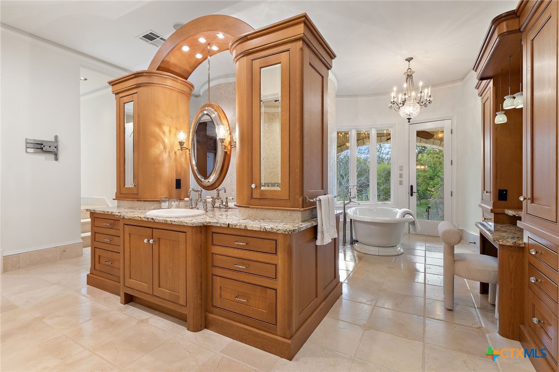 8536 Armstrong Road Belton, TX 76513 - Photo 15 of 41 a bathroom with a granite countertop sink and a mirror