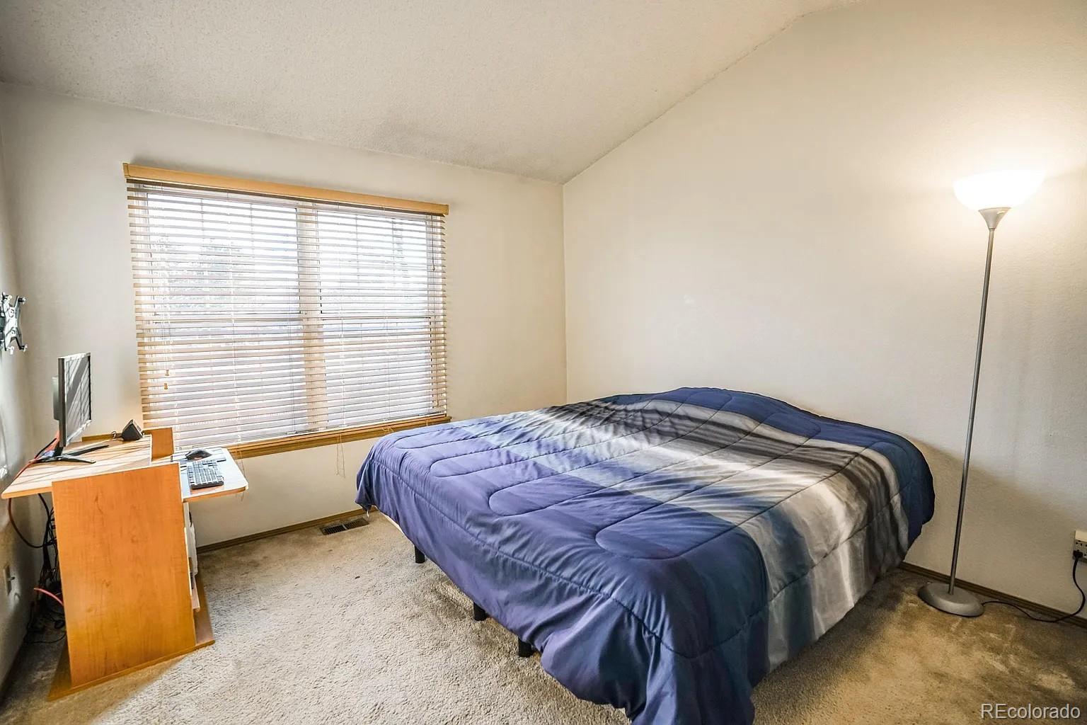 8280 South Fillmore Way Centennial, CO 80122 - Photo 6 of 10 a bedroom with a bed and a window
