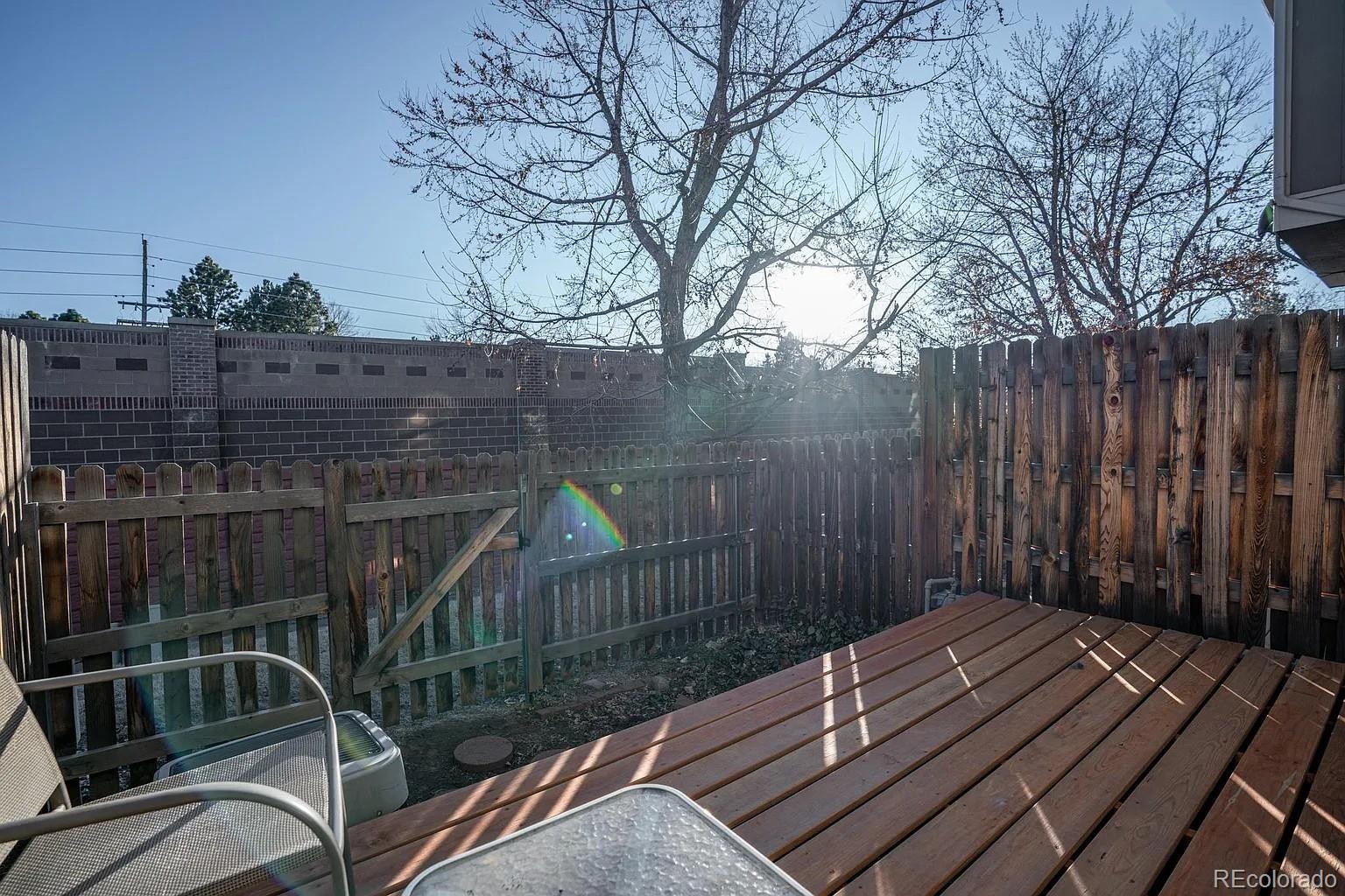 8280 South Fillmore Way Centennial, CO 80122 - Photo 9 of 10 a view of balcony with wooden floor and fence and trees