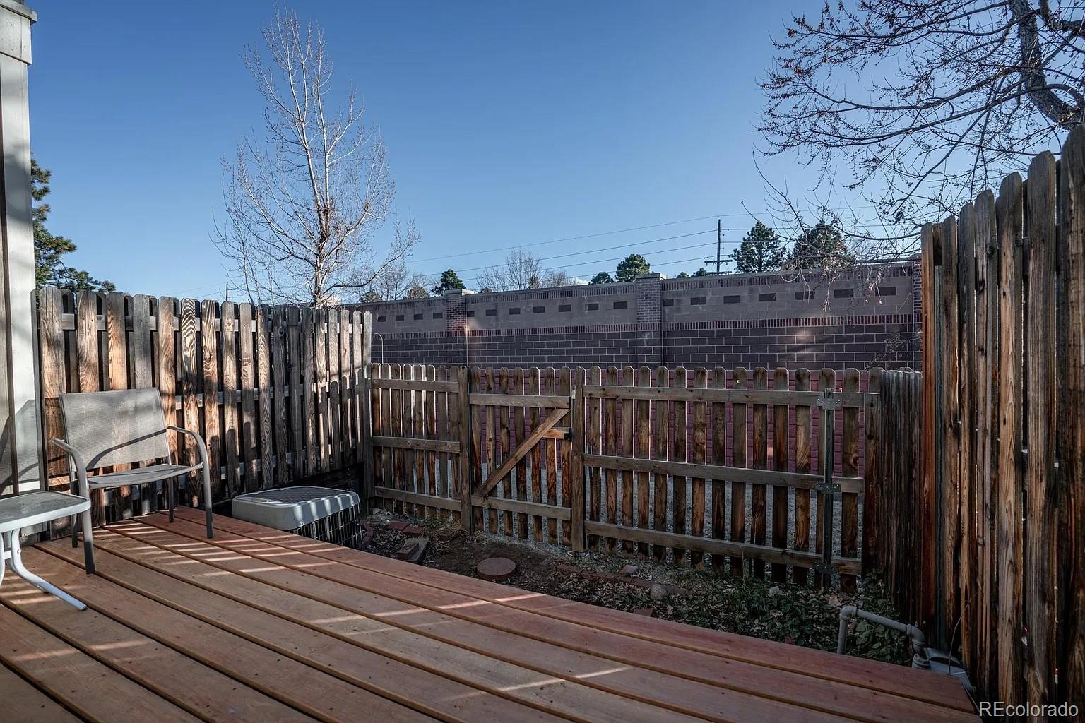 8280 South Fillmore Way Centennial, CO 80122 - Photo 10 of 10 a view of balcony with wooden floor and fence