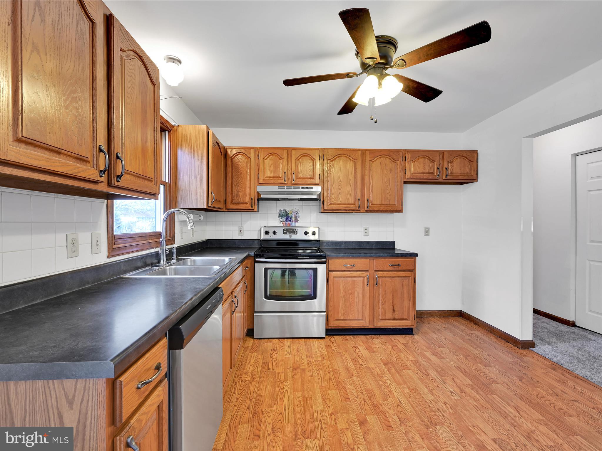 5 T-992 Stevens, PA 17578 - Photo 13 of 34 a kitchen with stainless steel appliances granite countertop a sink a stove and a refrigerator