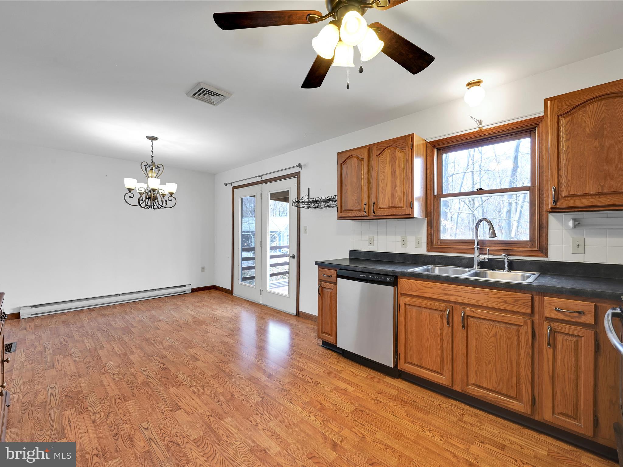 5 T-992 Stevens, PA 17578 - Photo 15 of 34 a kitchen with stainless steel appliances granite countertop a sink cabinets a stove and a window