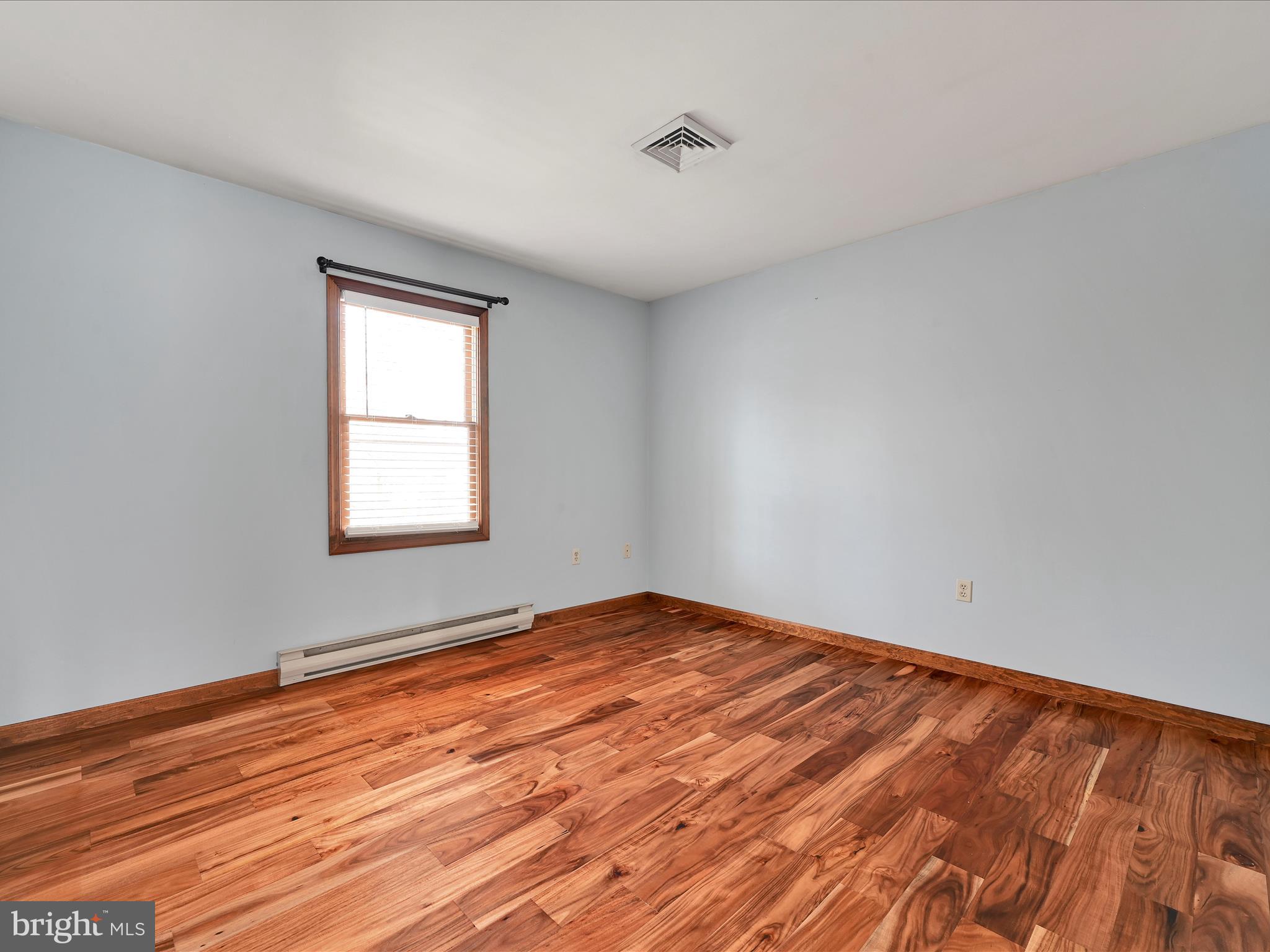 5 T-992 Stevens, PA 17578 - Photo 16 of 34 a view of empty room with wooden floor and fan