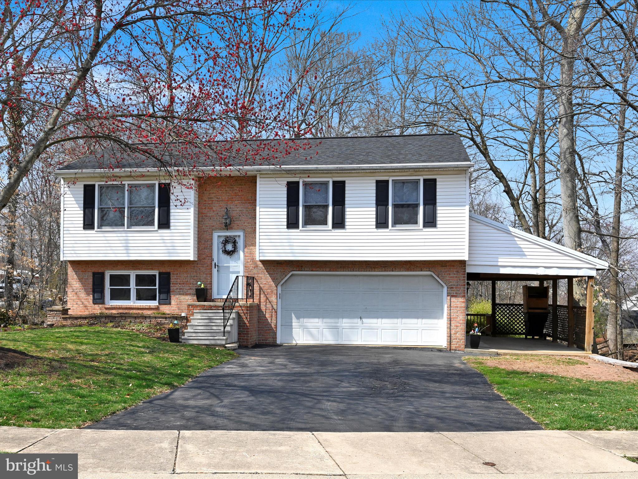 5 T-992 Stevens, PA 17578 - Photo 2 of 34 a front view of a house with a yard and garage