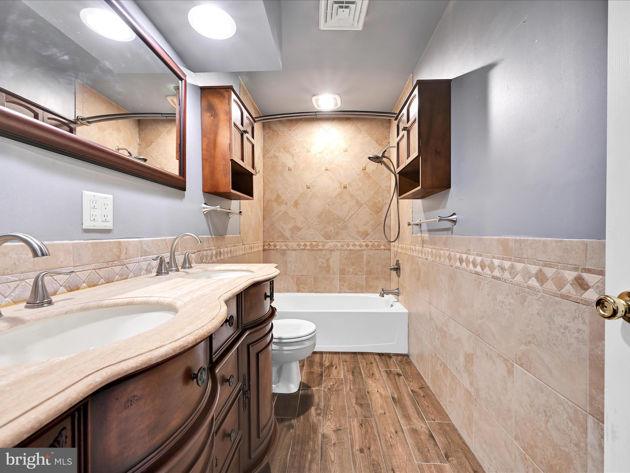 5 T-992 Stevens, PA 17578 - Photo 22 of 34 a bathroom with a sink a toilet a mirror and bathtub