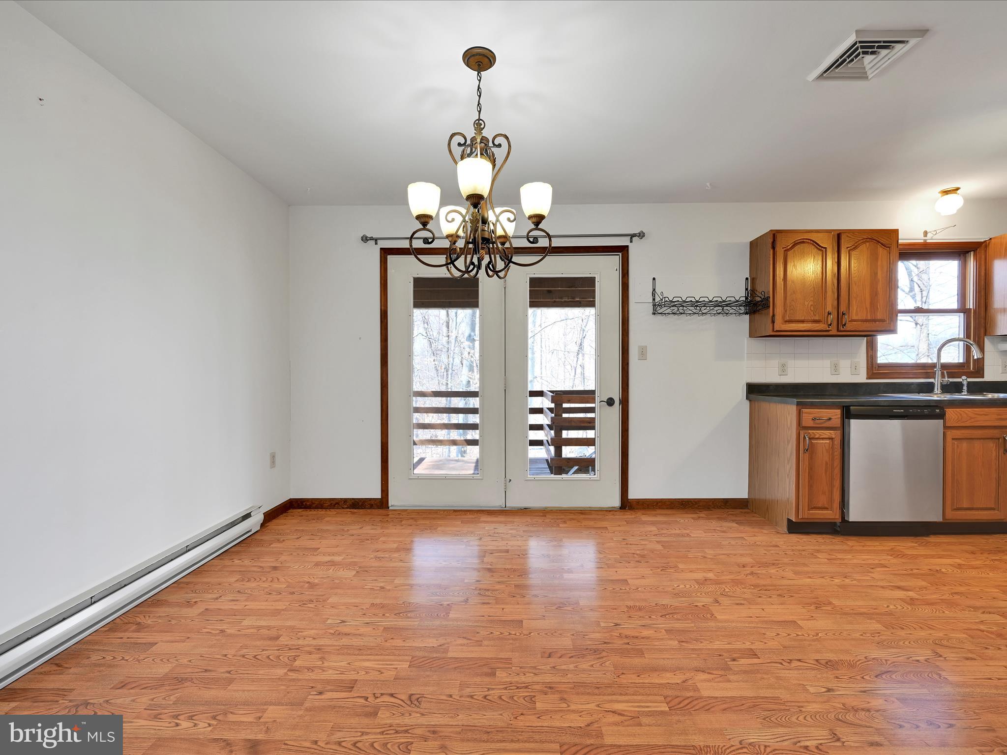 5 T-992 Stevens, PA 17578 - Photo 10 of 34 a view of a kitchen with granite countertop a stove top oven a sink dishwasher and microwave with wooden floor