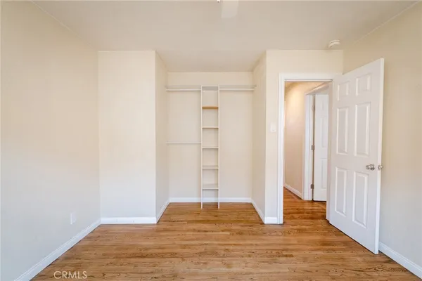 a view of a livingroom with wooden floor and closet