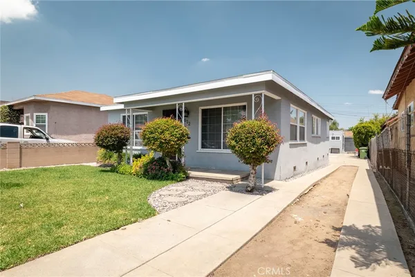 a front view of house with yard and outdoor seating