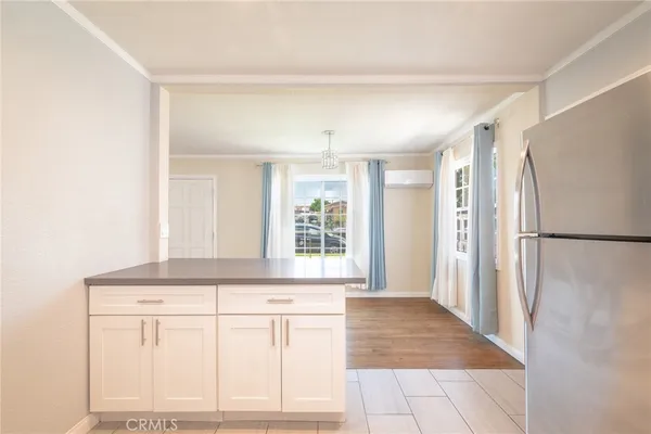 a view of a refrigerator in kitchen and wooden floor