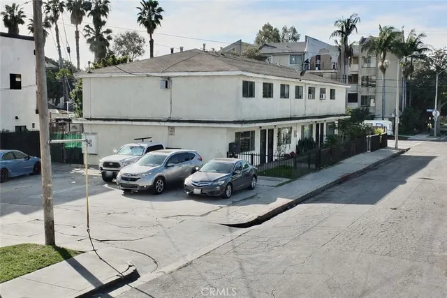 a couple of cars parked in front of house