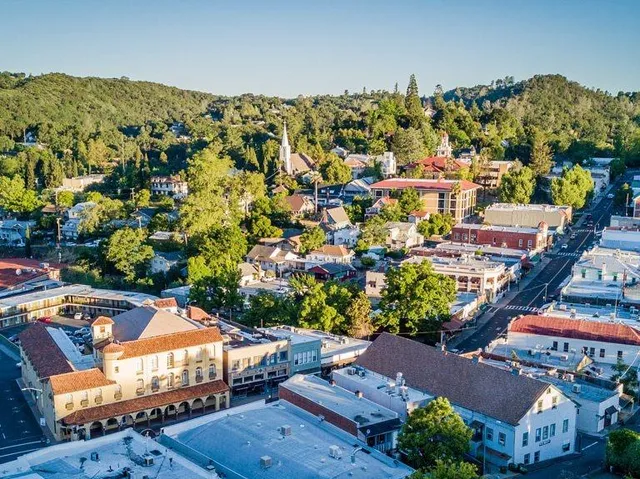 an aerial view of a houses with yard