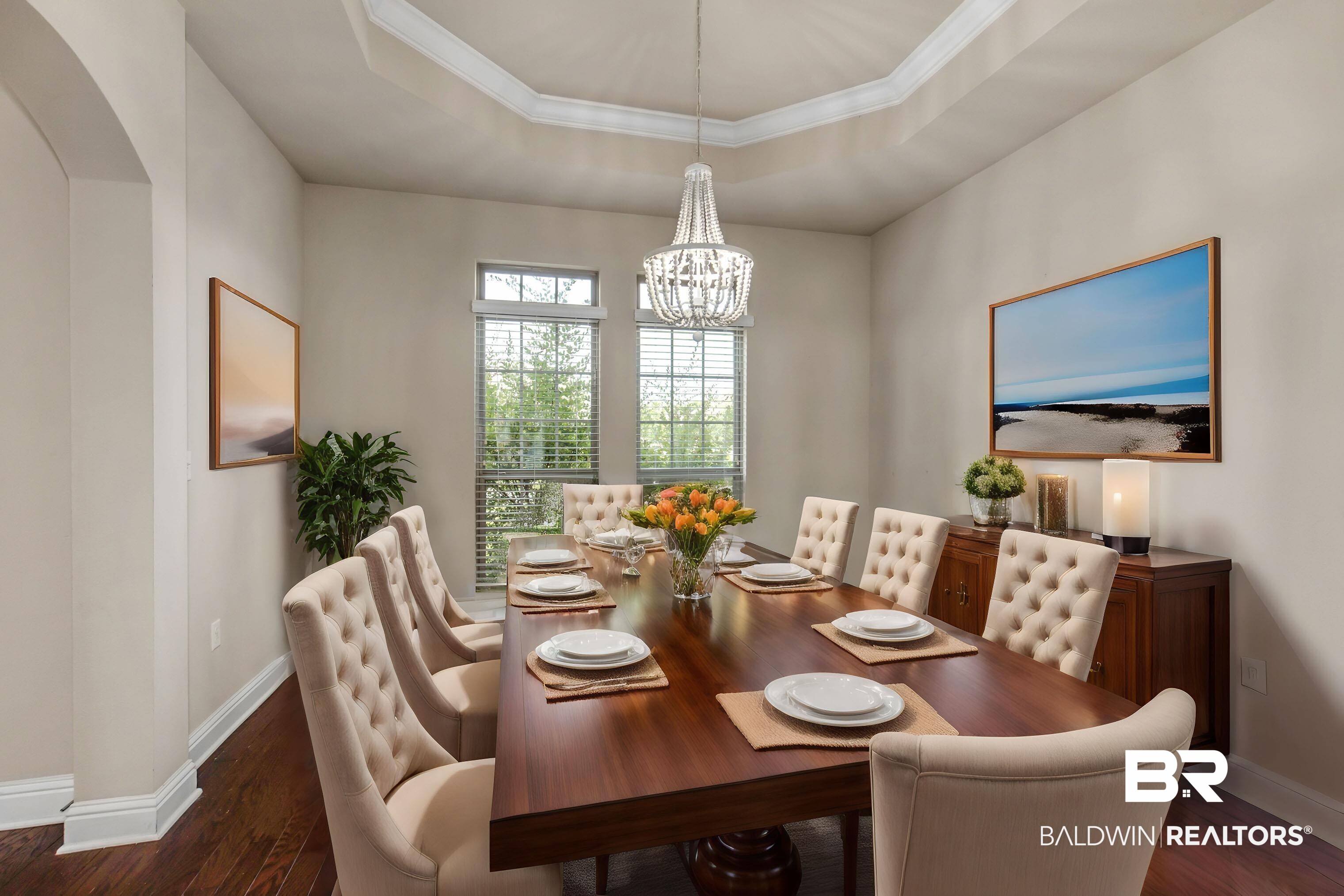122 Open Field Drive Fairhope, AL 36532 - Photo 11 of 27 Dining area featuring a notable chandelier, dark hardwood / wood-style flooring, and a tray ceiling