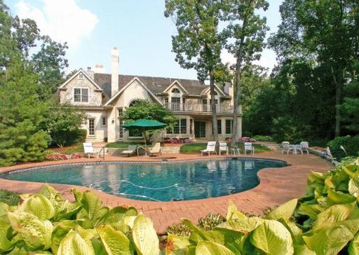 a view of a house with swimming pool and sitting area