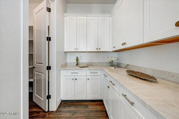 a large kitchen with stainless steel appliances kitchen island granite countertop a lot of counter space and a sink