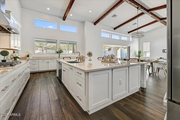 a spacious bedroom with a bed a table and chair