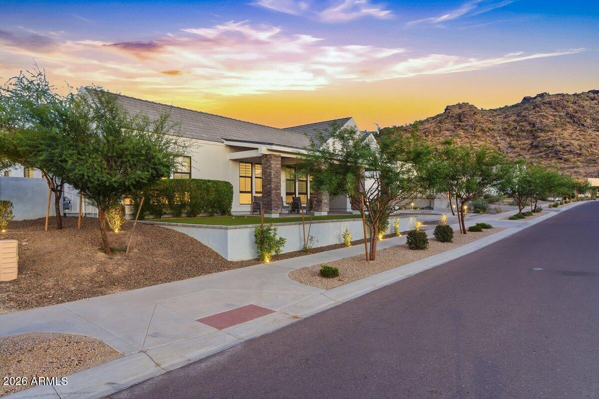 9407 South 13th Way Phoenix, AZ 85042 - Photo 47 of 51 a front view of a house with a yard and garage