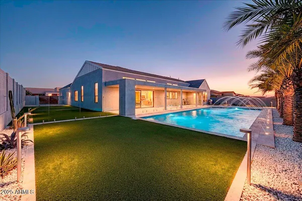 a living room with lots of furniture and kitchen view