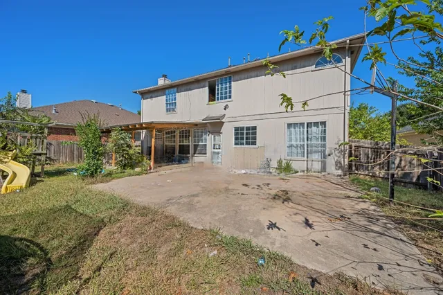 a view of a white house with a yard