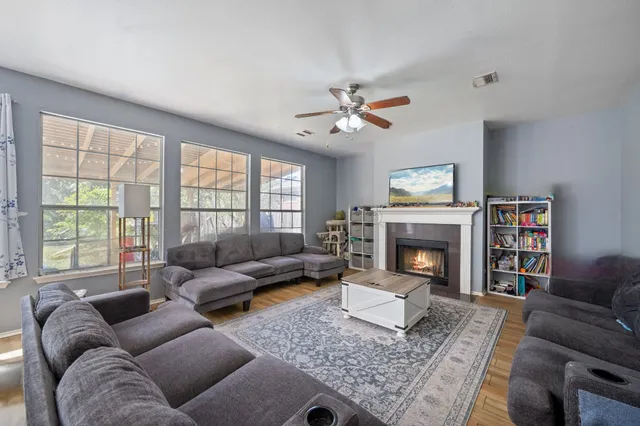 a living room with furniture and a fireplace