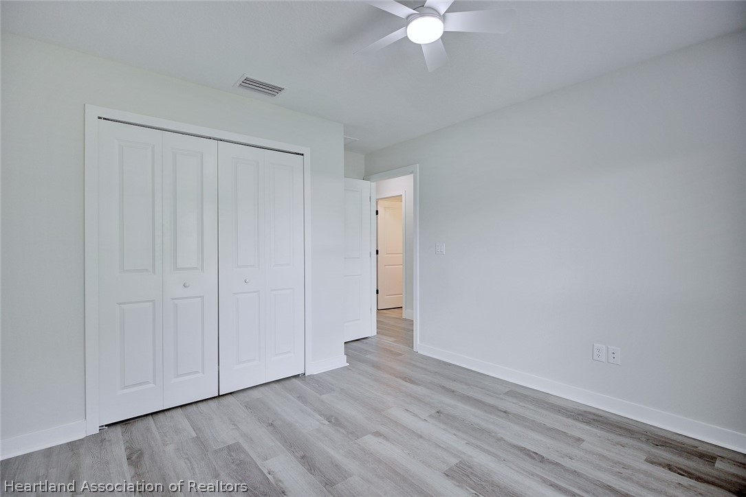 111 Vale Court Sebring, FL 33876 - Photo 26 of 40 a view of an empty room with wooden floor