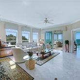a living room with furniture large window and glass door
