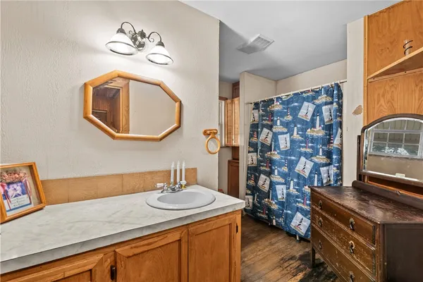 a bathroom with a sink a vanity and a mirror