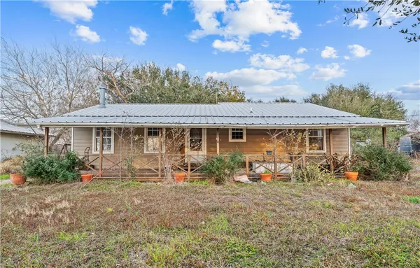 a front view of house with yard outdoor seating and barbeque oven